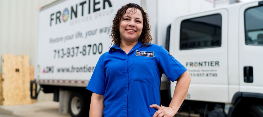 Female Employee in Front of Frontier Truck